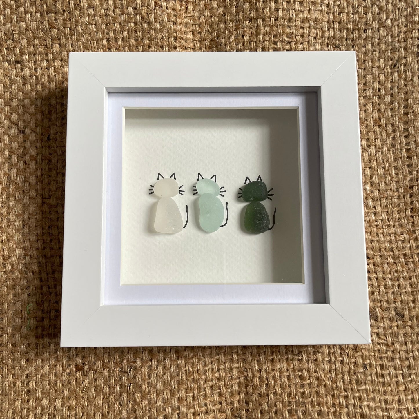 Sea glass cats in frame, 3x cats, white seaglass, blue seaglass and green seaglass cats