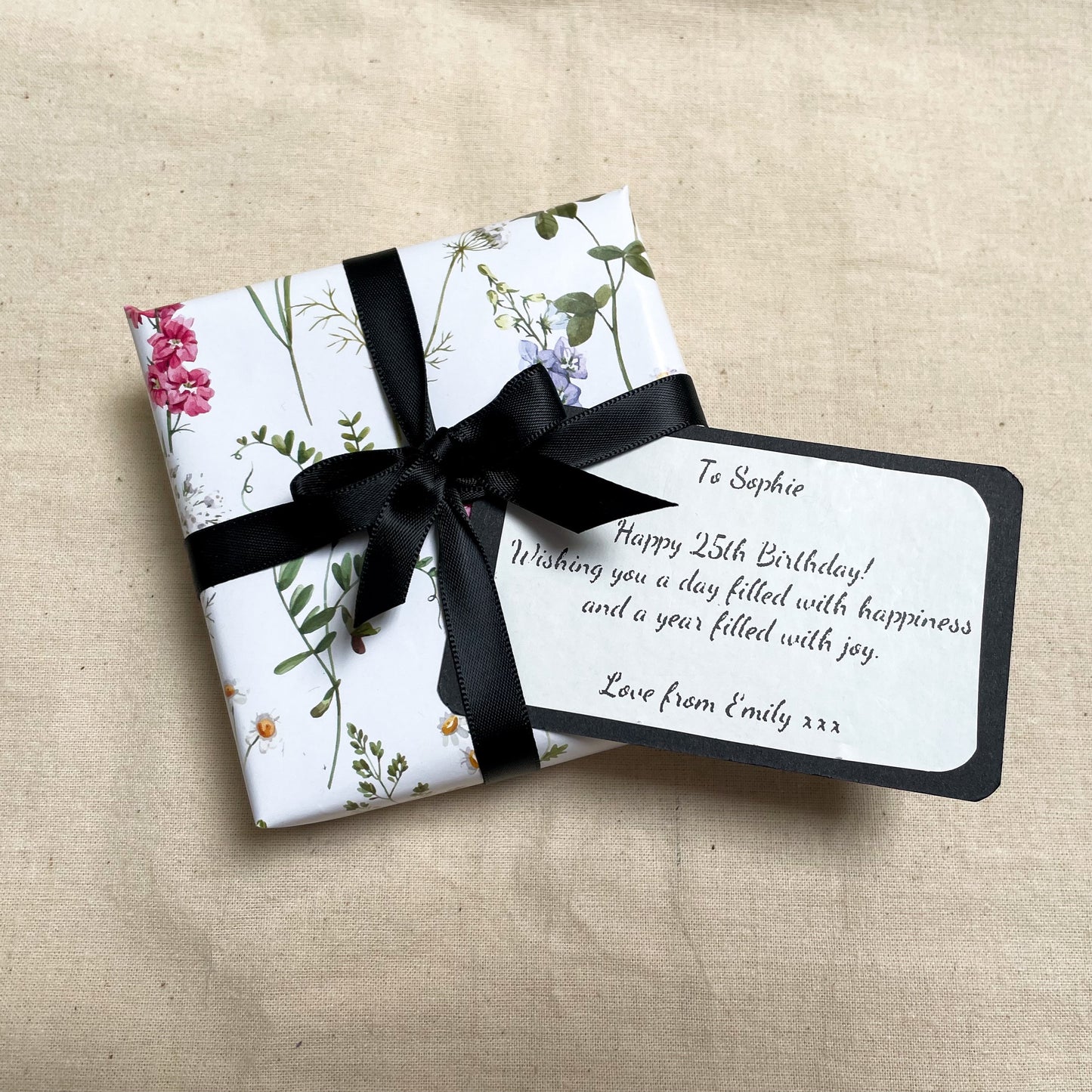 necklace gift box wrapped up with a black ribbon and note