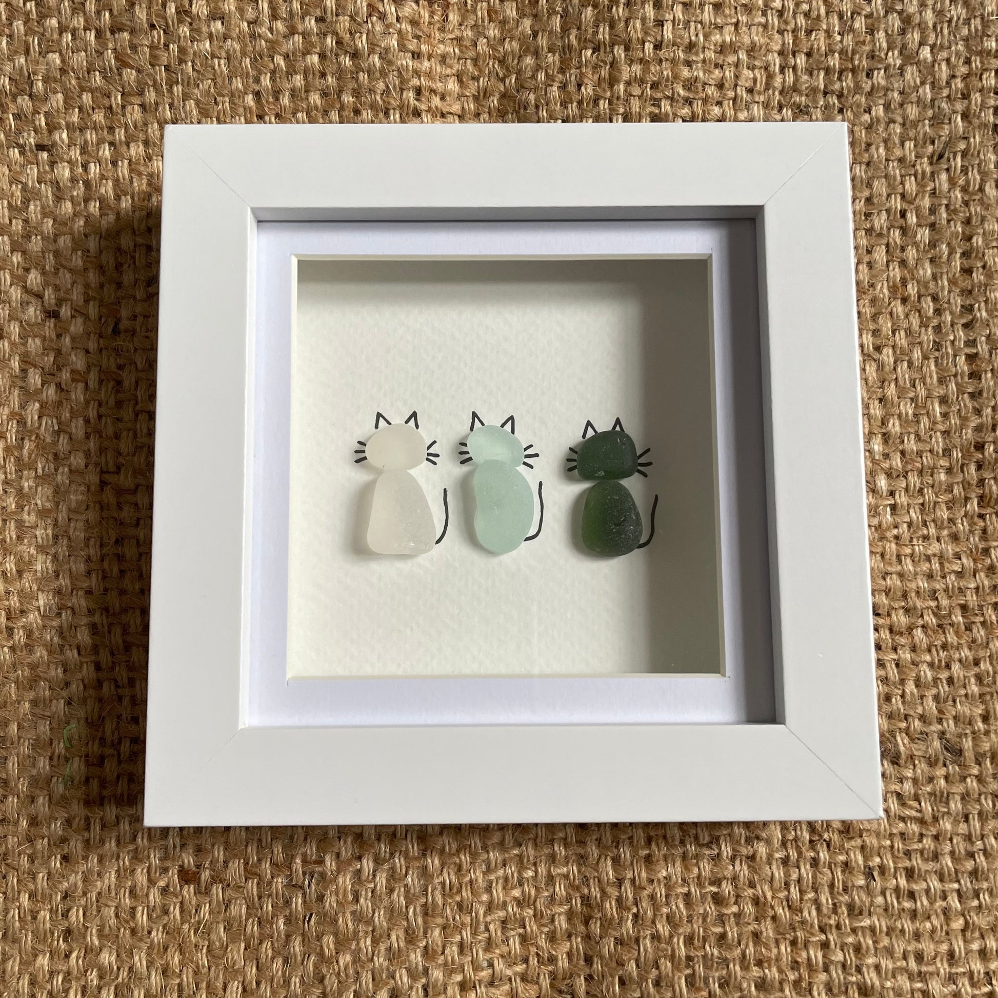 Sea glass cats in frame, 3x cats, white seaglass, blue seaglass and green seaglass cats 