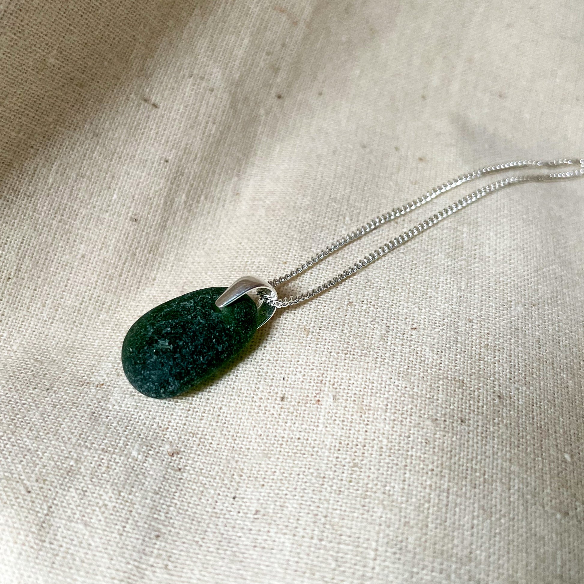 green sea glass pendant on silver chain