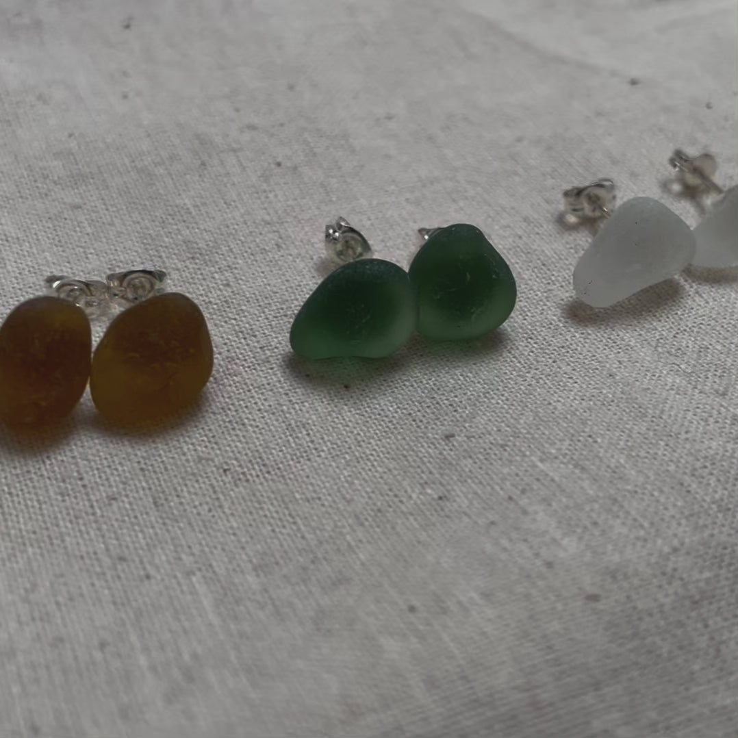 Four pairs of sea glass and sterling silver stud earrings in yellow (left), green (middle), white (middle) & light blue (right)