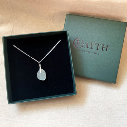 light blue sea glass necklace on a fine silver chain in a dark green gift box with black foam insert