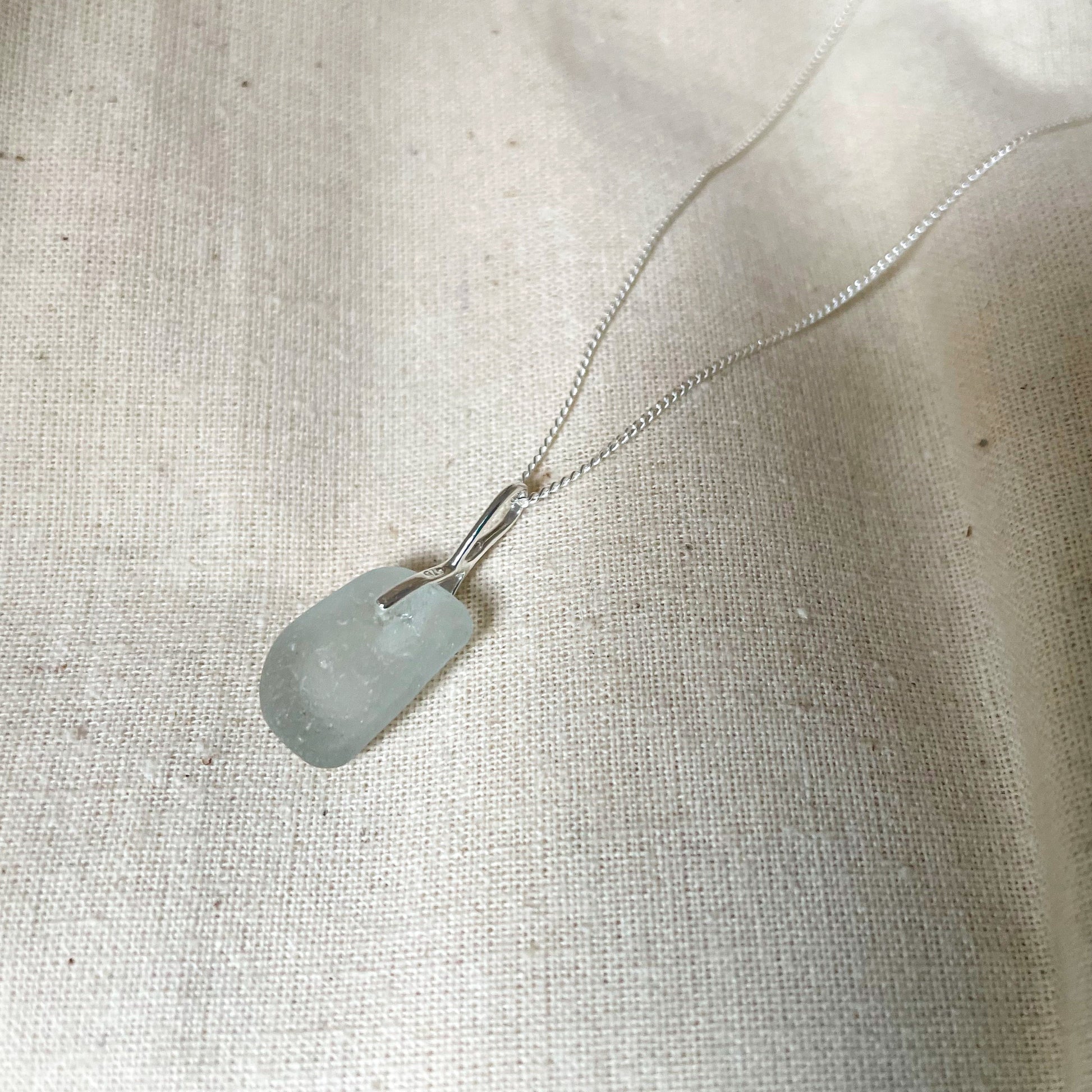 Back of white sea glass pendant